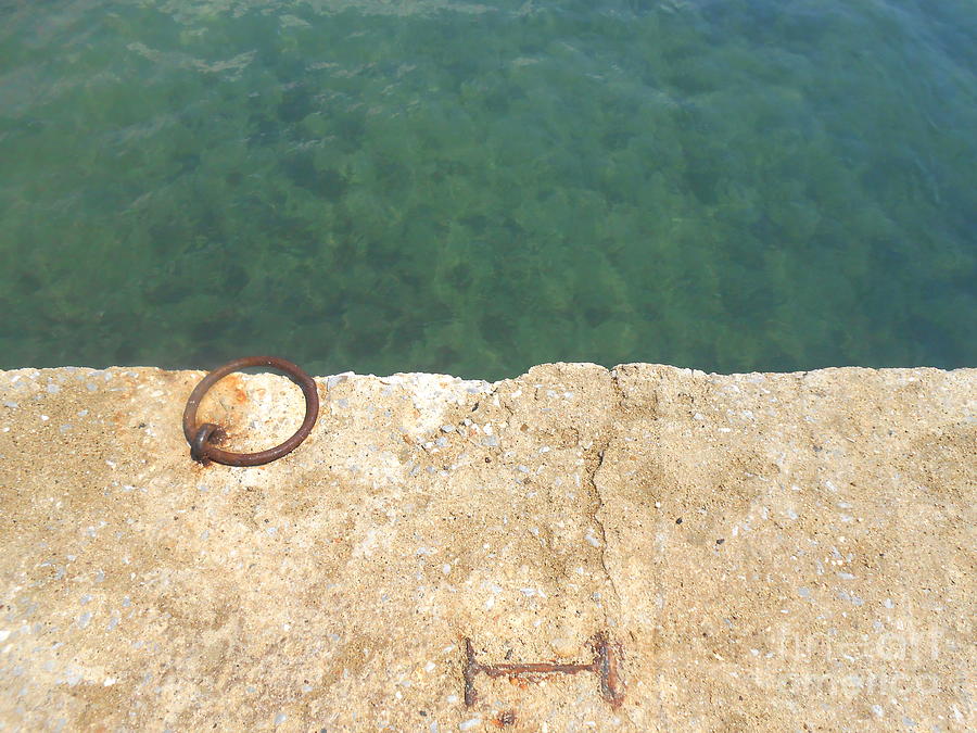 Abstract Photograph - Teal waters and a rusty ring on a dock by Ioanna Papanikolaou
