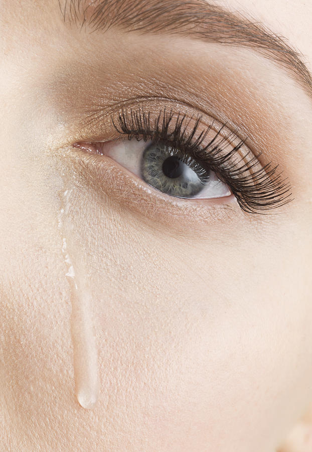 Tears down female face, close up Photograph by Jonathan Knowles