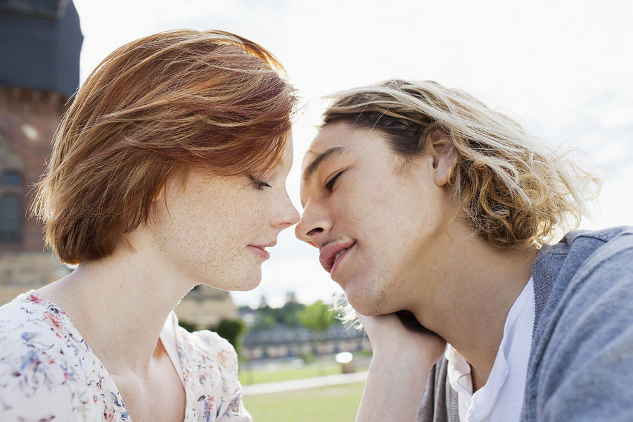 Teen (16-17) couple kissing Photograph by Oliver Rossi