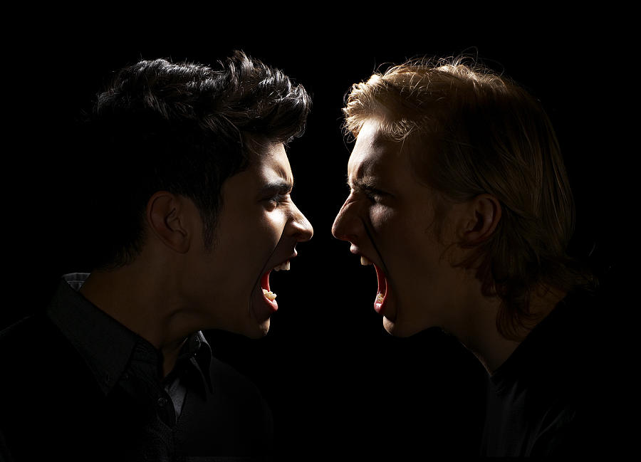 Teen Boy and Adult Male Yelling Photograph by Thomas Northcut