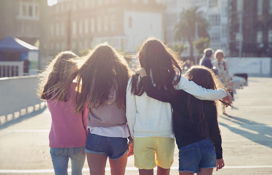 Teen girls walking together on a beautiful sunny day. Photograph by Sol de Zuasnabar Brebbia