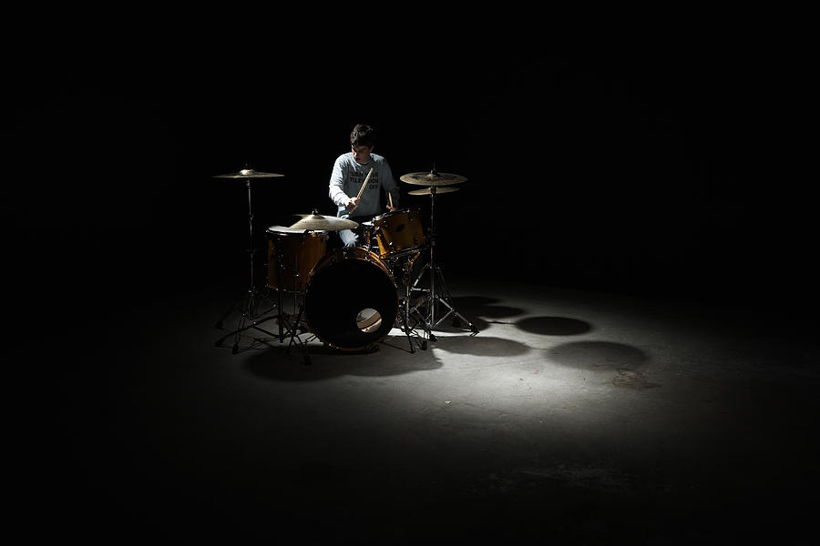 Teenage boy (13-15) playing drums Photograph by Thomas Northcut