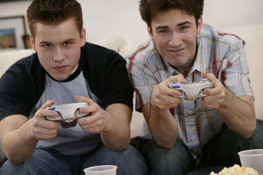 Teenage boys playing video games Photograph by Comstock Images