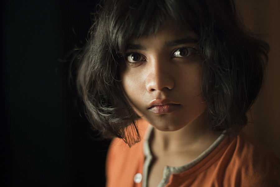 Teenage girl looking at camera with blank expression. Photograph by Gawrav Sinha