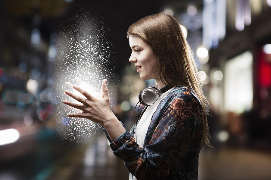 Teenage Girl Looks At Energy Source Between Hands. Photograph by Betsie Van der Meer