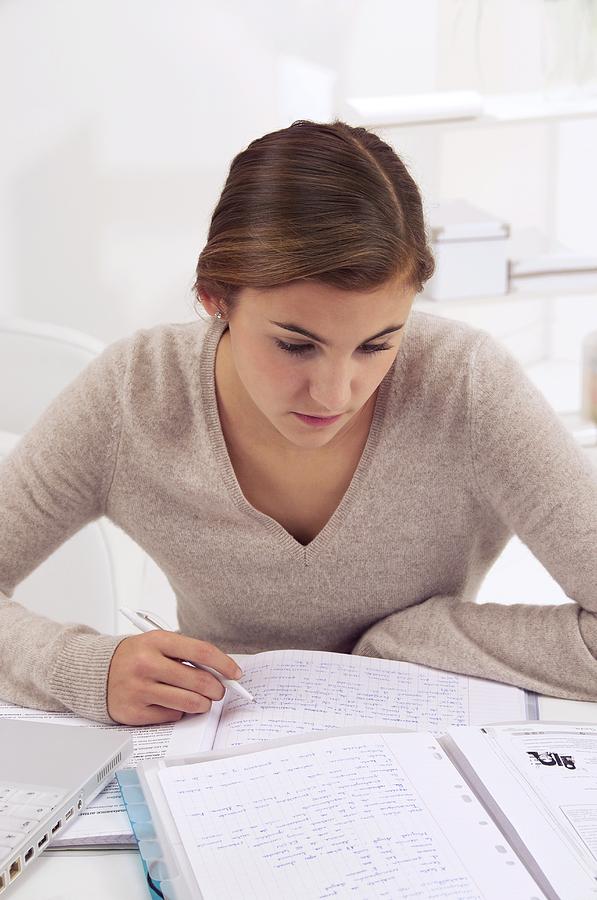 University Photograph - Teenage girl studying by Science Photo Library