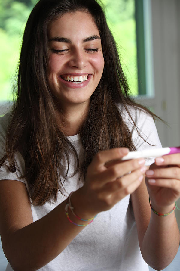 Teenage Girl With A Pregnancy Test Photograph by Mauro Fermariello