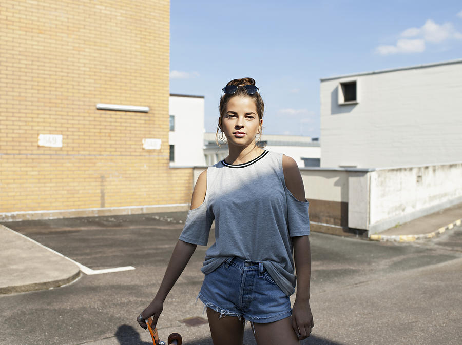 Teenage girl with skateboard Photograph by Joos Mind