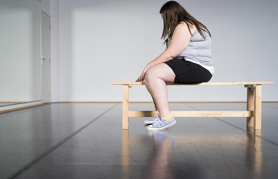 Teenage overweight girl in gym Photograph by Roos Koole