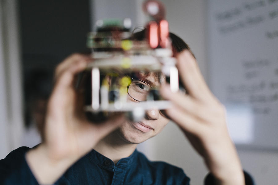 Teenager admiring homemade Robot Photograph by Willie B. Thomas