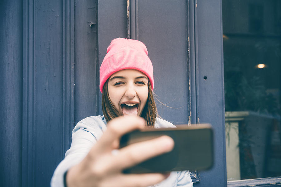 Teenager girl make selfie and making grimaces Photograph by Nikada