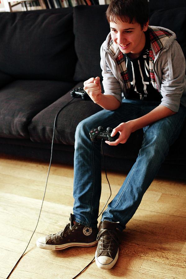 Teenager Playing A Video Game Photograph by Mauro Fermariello/science Photo Library