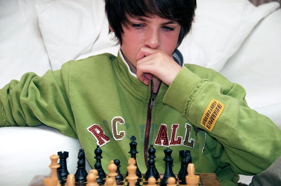 Teenager Playing Chess Photograph by Lea Paterson/science Photo Library