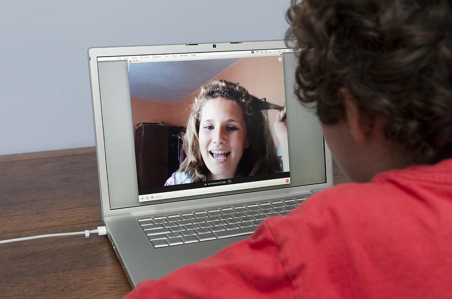 Teenagers talking via video call Photograph by Alex Segre