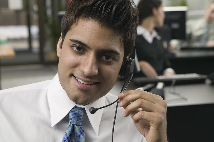 Telemarketer with telephone headset Photograph by Comstock Images