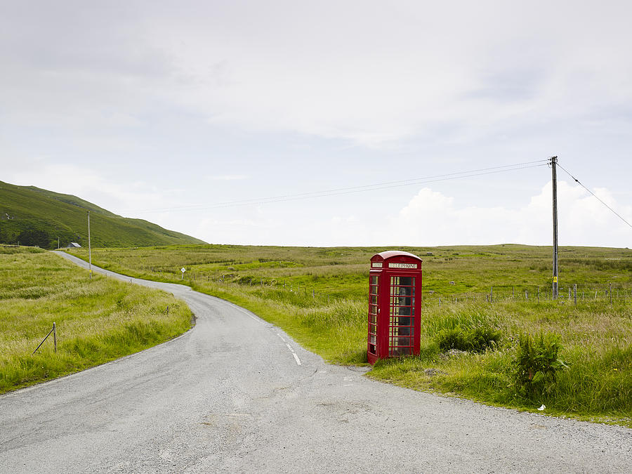 Telephone booth on side of country road Photograph by Johner Images