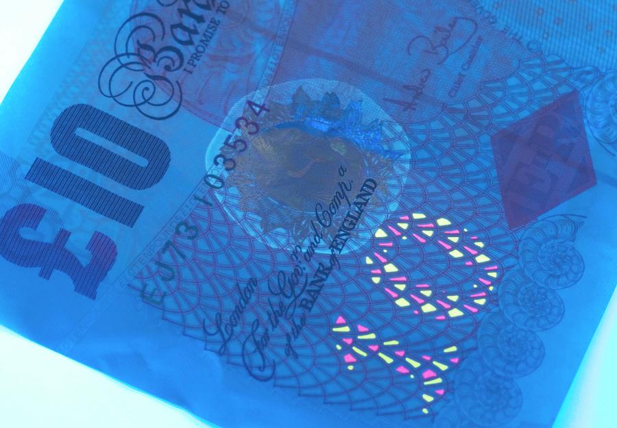 Banknote Photograph - Ten Pound Banknote In Uv Light by Louise Murray/science Photo Library