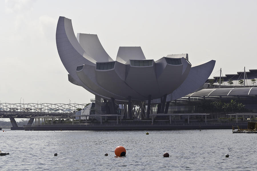 The ArtScience museum in Singapore with a plastic float in the w ...