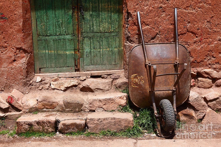 Rusty Wheelbarrow and Green Door Photograph by James Brunker