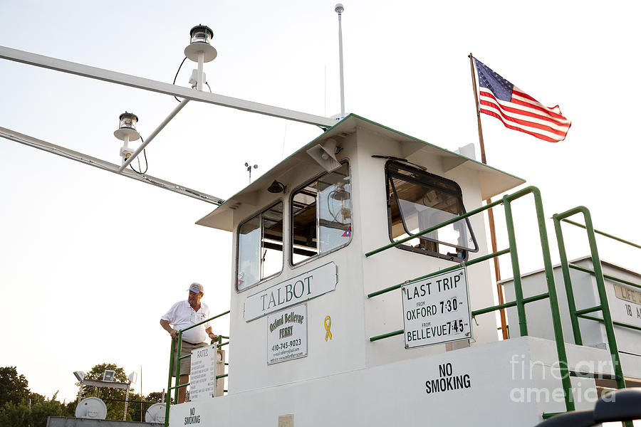 The captain climbs to the bridge on the Oxford-Bellevue Ferry in Oxford Maryland Photograph by William Kuta