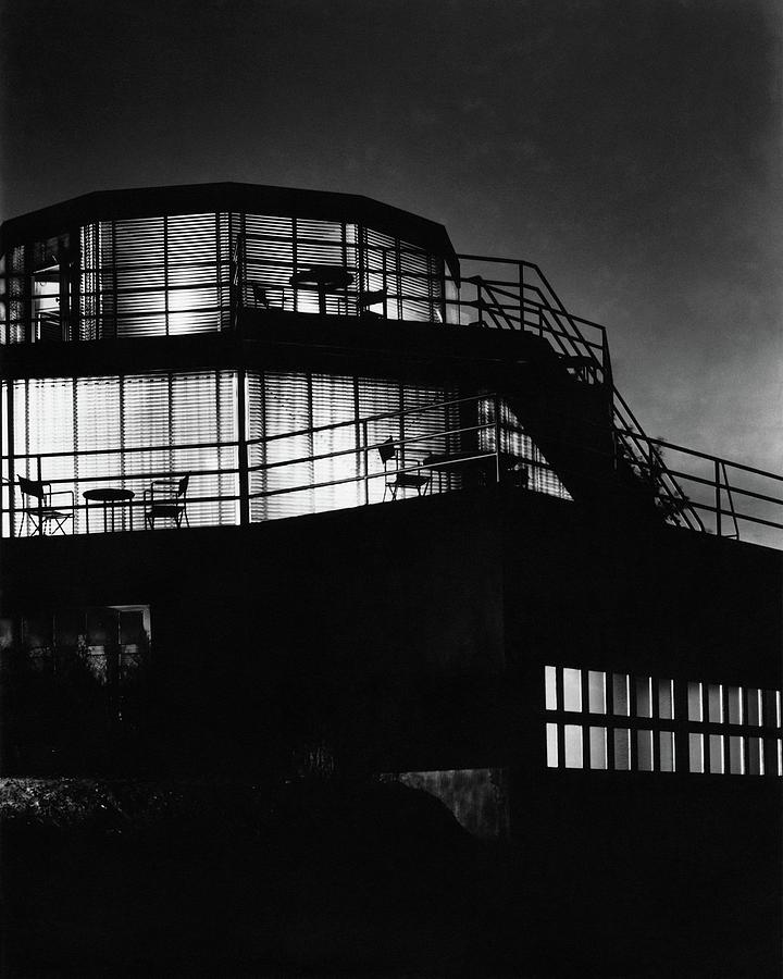 The Exterior Of A Spiral House Design At Night Photograph by Eugene Hutchinson