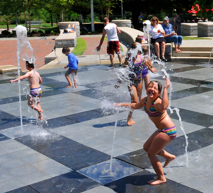 Joyful Young Girl Playing in Fountain Photograph by Ginger Wakem