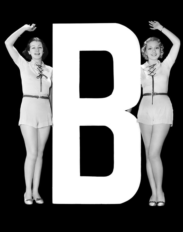 Black And White Photograph - The Letter B And Two Women by Underwood Archives