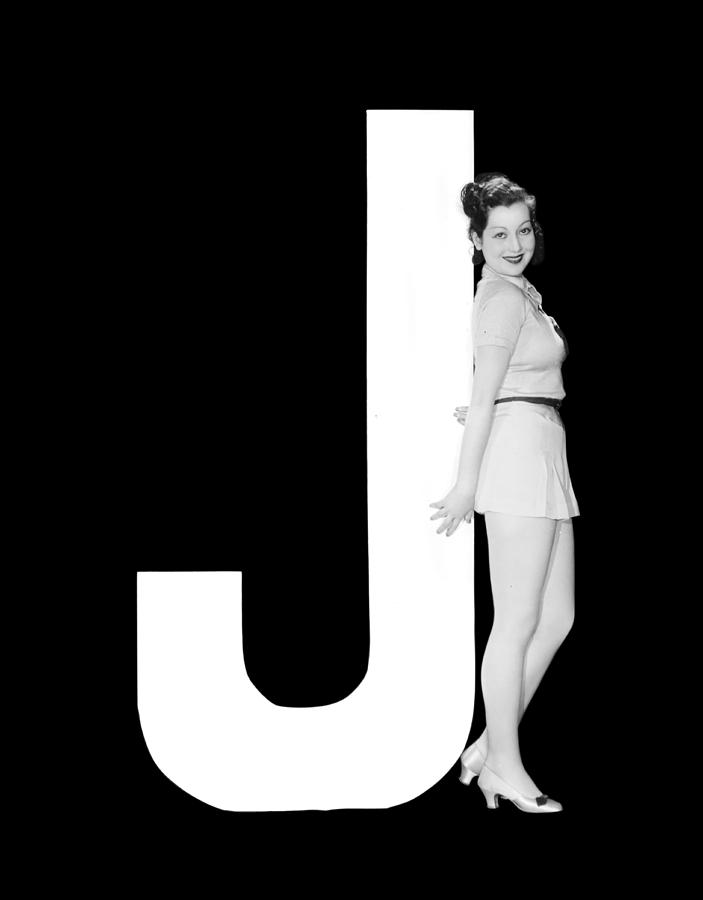 Black And White Photograph - The Letter J And A Woman by Underwood Archives