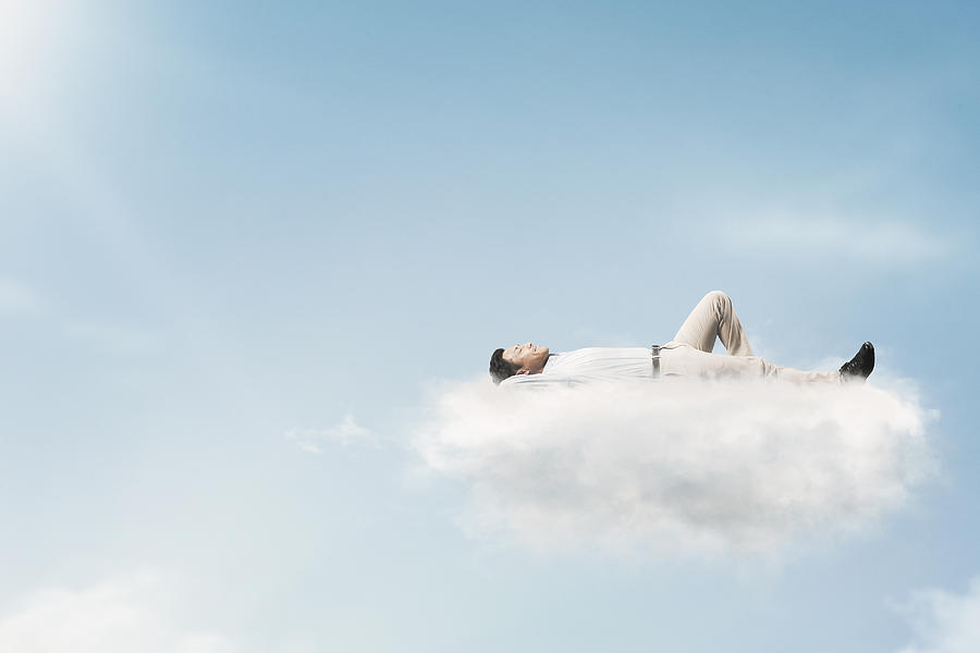The man is relaxing in the clouds Photograph by Yagi Studio
