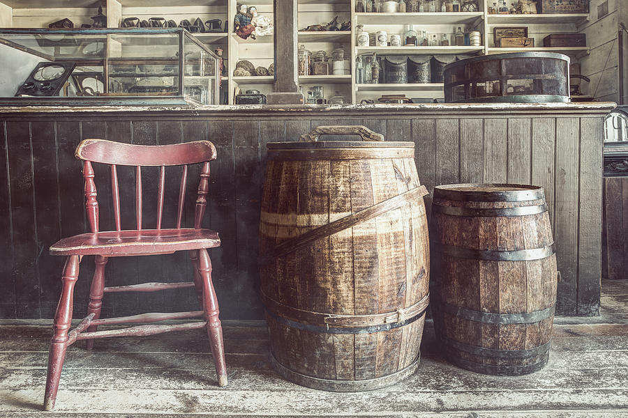 The Old General Store - Red chair and Barrels in this 19th Century Store Photograph by Gary Heller