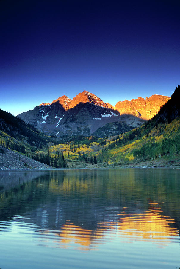 The Sun Rises Above A Mountain Lake Photograph by David Clifford