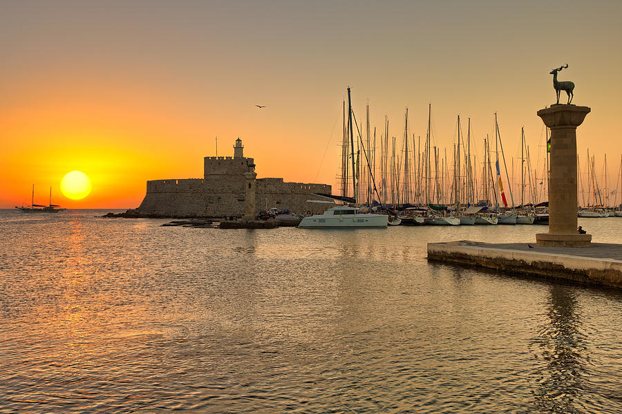 The sunrise at the old port of Rhodes - Greece Photograph by Constantinos Iliopoulos