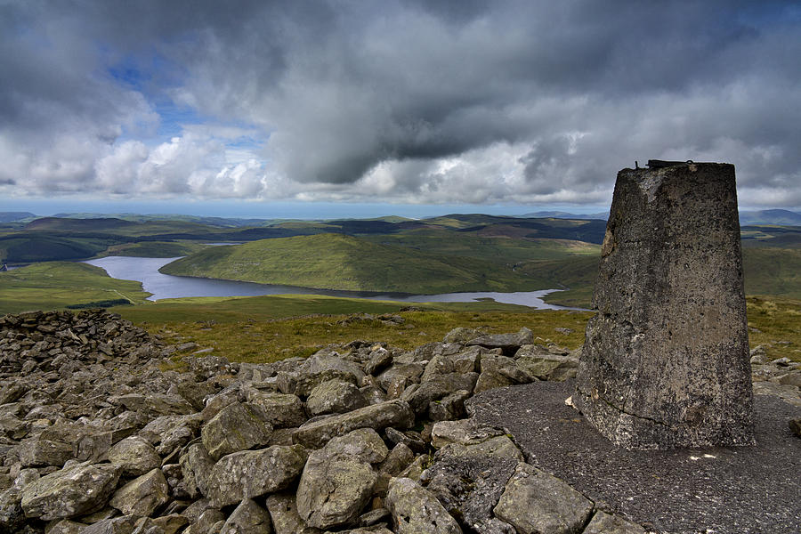The trig point on the summit of Plynlimon, or Pen Pumlumon Fawr, overlooking Nant-y-Moch reservoir in the Cambrian mountains, Wales Photograph by Michael Roberts