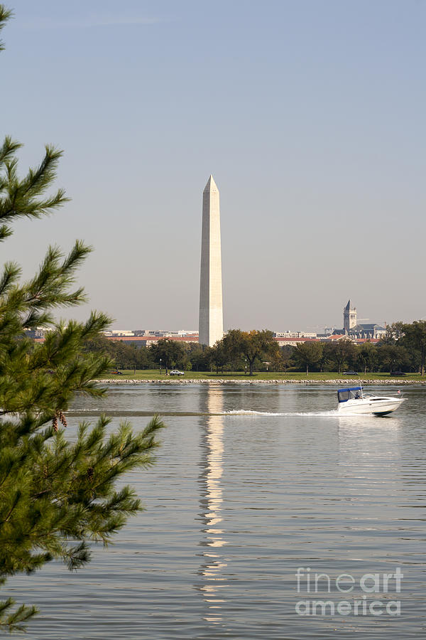 The Washington Monument reflects on the Potomac River as viewed from the Virginia side Photograph by William Kuta