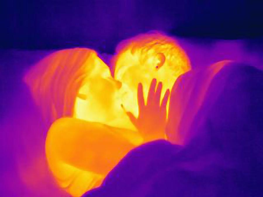 Thermal image of young couple kissing in bed Photograph by Cultura RM Exclusive/Joseph Giacomin