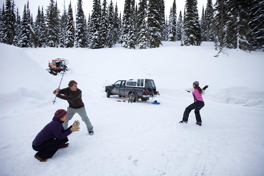 Three Adults Playing Snow Baseball Photograph by Woods Wheatcroft