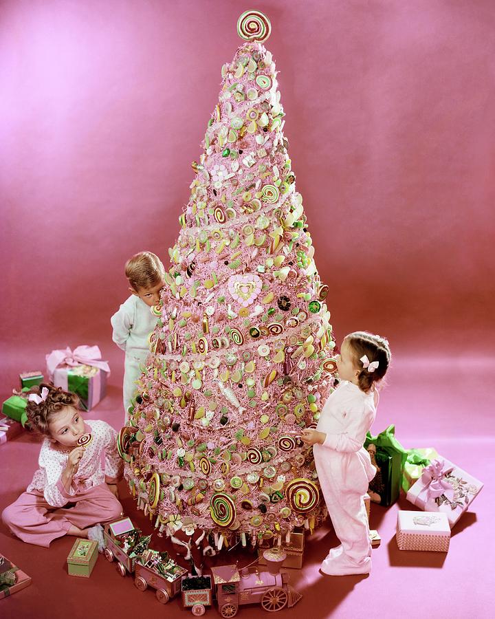 Three Children Eating A Candy Christmas Tree Photograph by Herbert Matter
