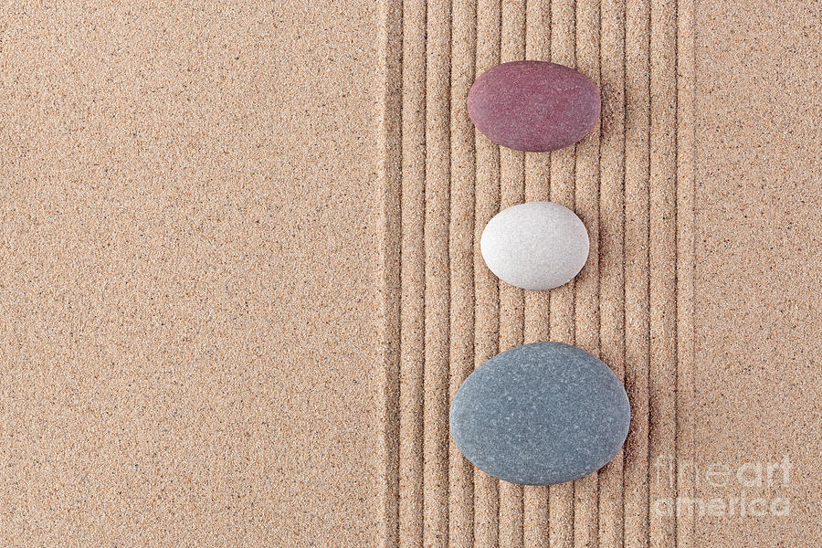 Three Coloured Pebbles On Raked Sand Photograph