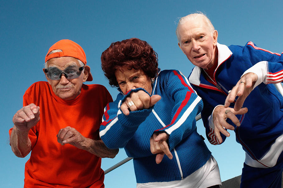 Three elderly people posing as youth Photograph by Image Source