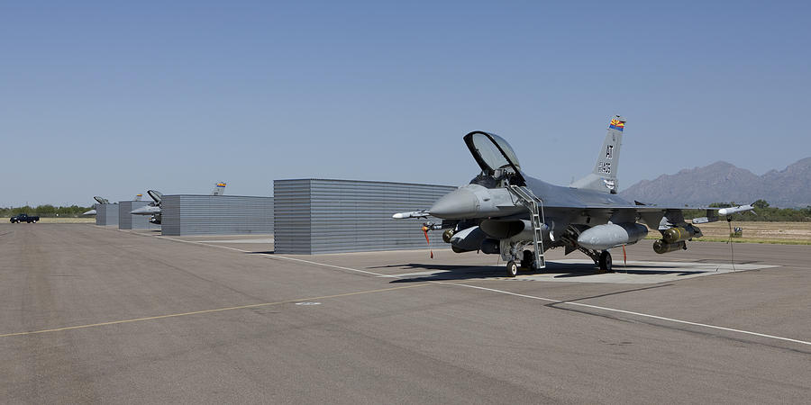 Three F-16s from the Air National Guard Air Force Reserve Test Center sit in the revetments at Davis-Monthan Air Force Base prior to a test mission. Photograph by HIGH-G Productions/Stocktrek Images