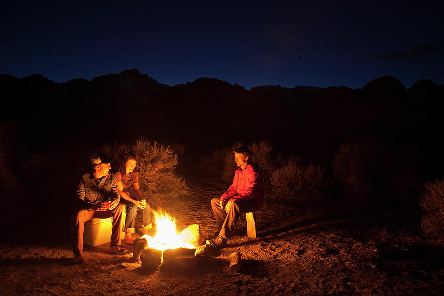 Three Friends Sitting Around Campfire Photograph by Woods Wheatcroft ...