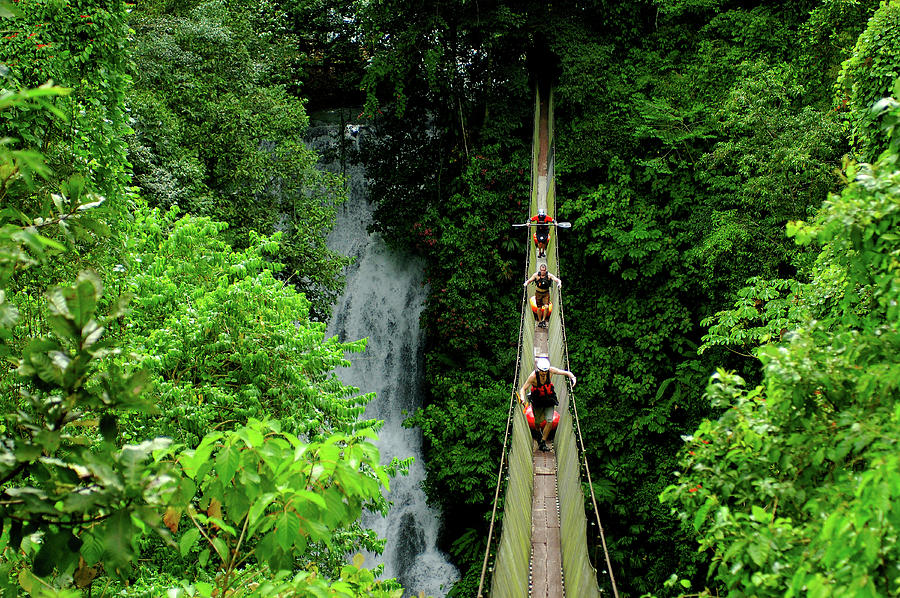 Jungle Photograph - Three Kayakers Cross A Perilous by Lucas Gilman