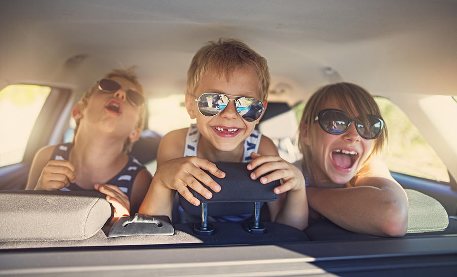 Three kids having fun on road trip Photograph by Imgorthand