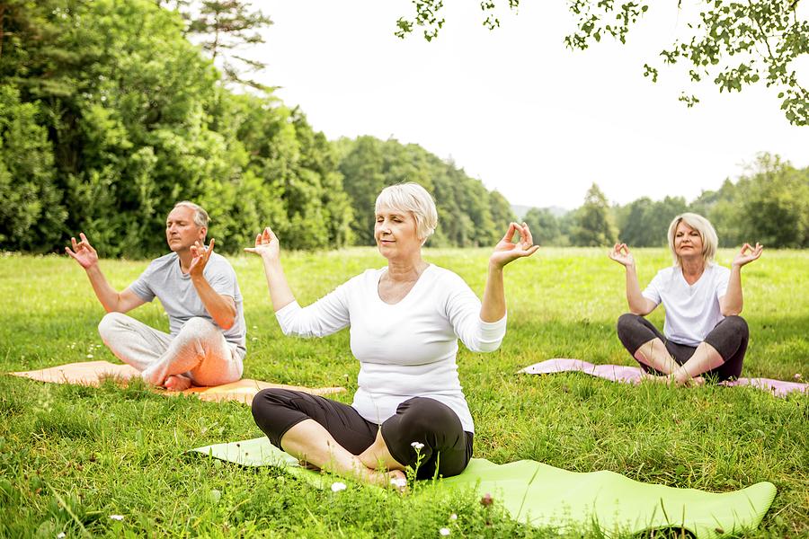 Three People Doing Yoga In Field Photograph by Science Photo Library ...