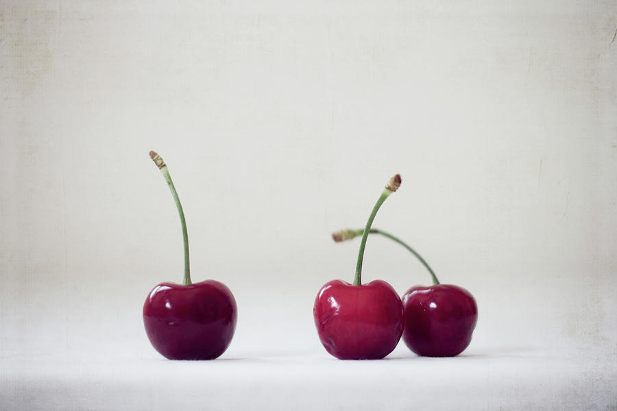 Three Red Cherries On White Background Photograph by Copyright Anna Nemoy(xaomena)
