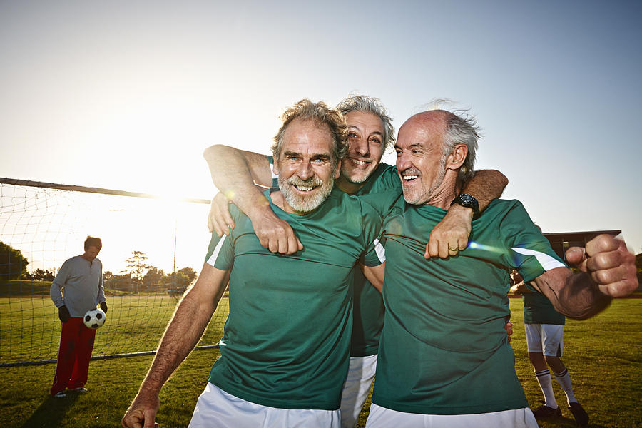 Three senior male soccer players celebrating Photograph by Uwe Krejci