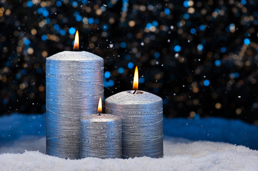 Three Silver Candles in snow  Photograph by U Schade