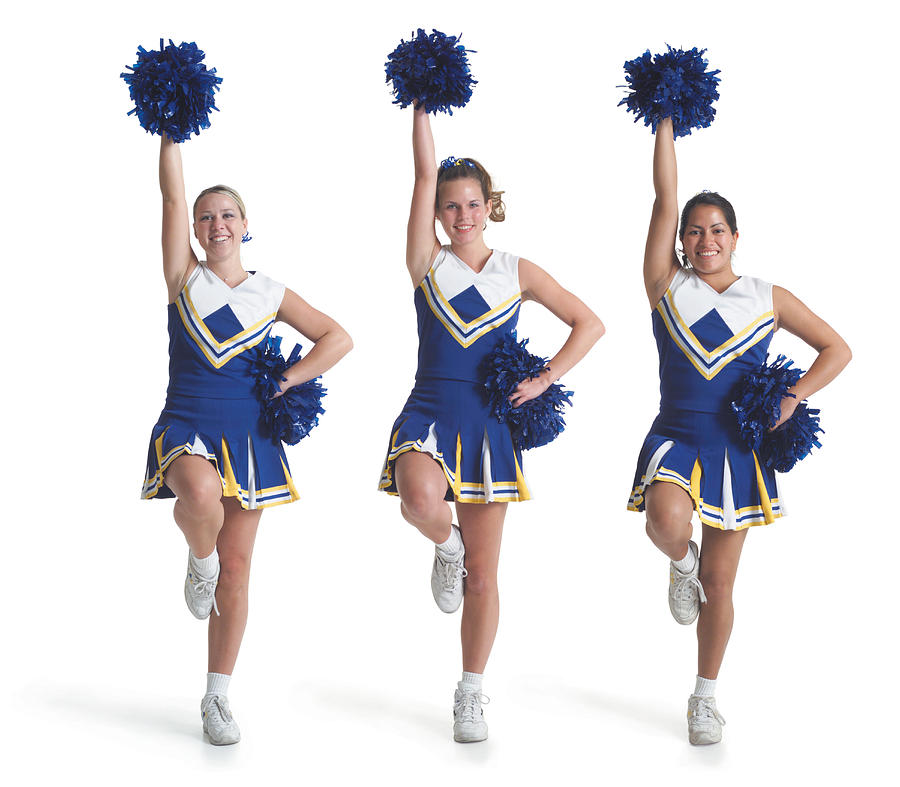 Three Teenage Caucasian Female Cheerleaders In Blue Uniforms Do A Routine And Raise Their Pom Poms In The Air Photograph by Photodisc