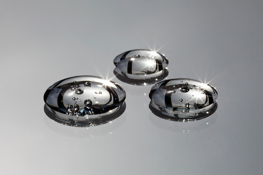 Three Water Drops With Bubbles In Them Photograph by Ralf Hiemisch