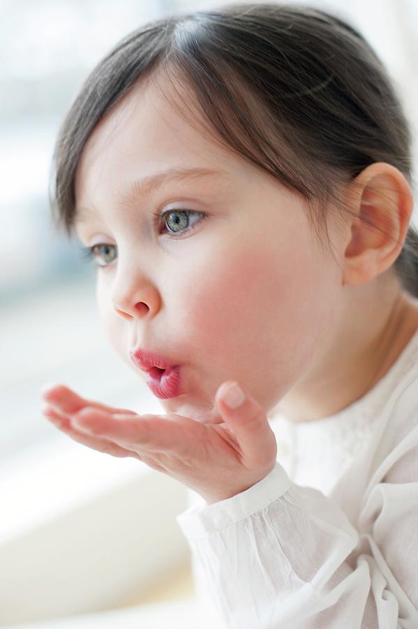 Three Year Old Girl Blowing A Kiss Photograph by Ian Hooton/science ...